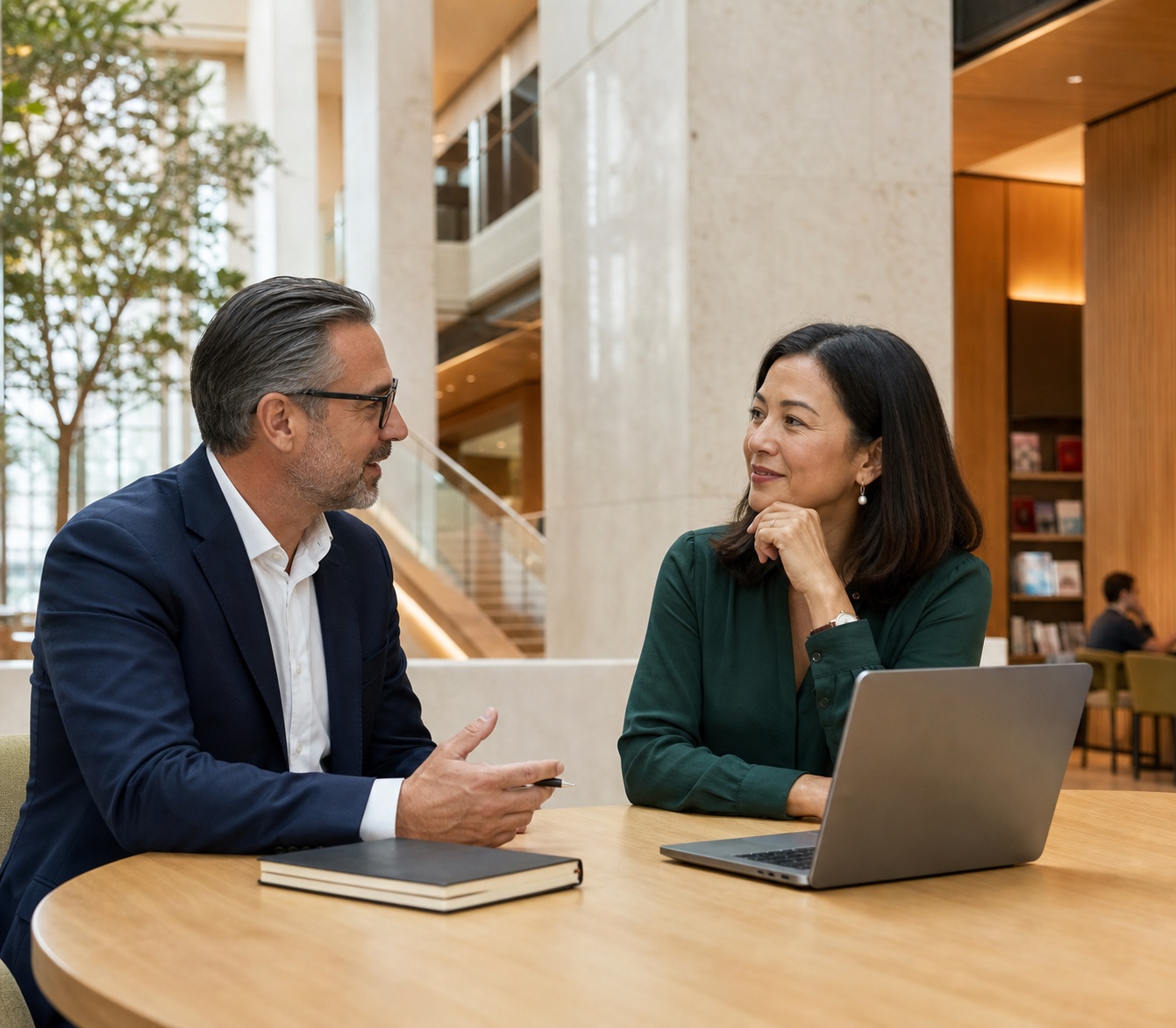 Australian career coach and mid-career professional discussing next-step options in a contemporary civic workplace.