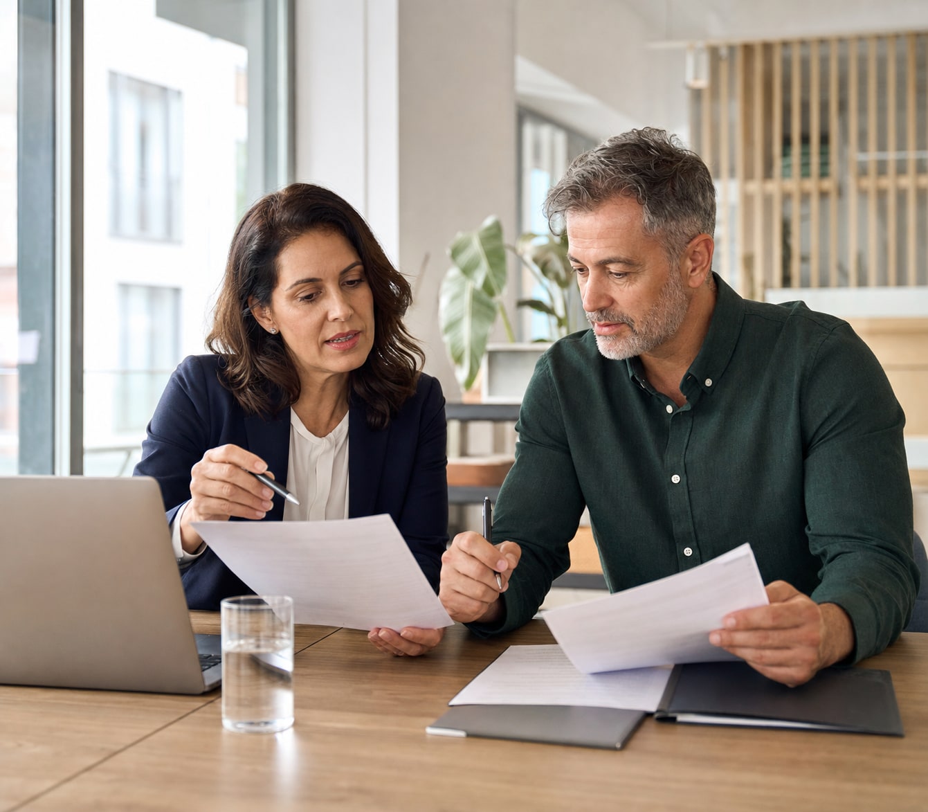 Career adviser and public-sector professional refining a concise application pitch together.