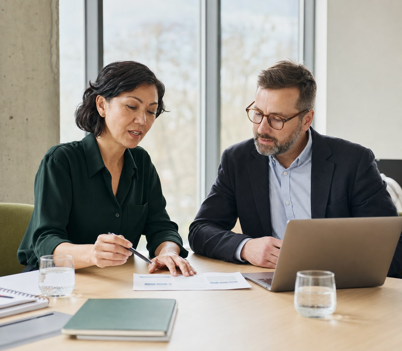 Career adviser and public-sector professional reviewing an application example together in a contemporary Australian workplace.