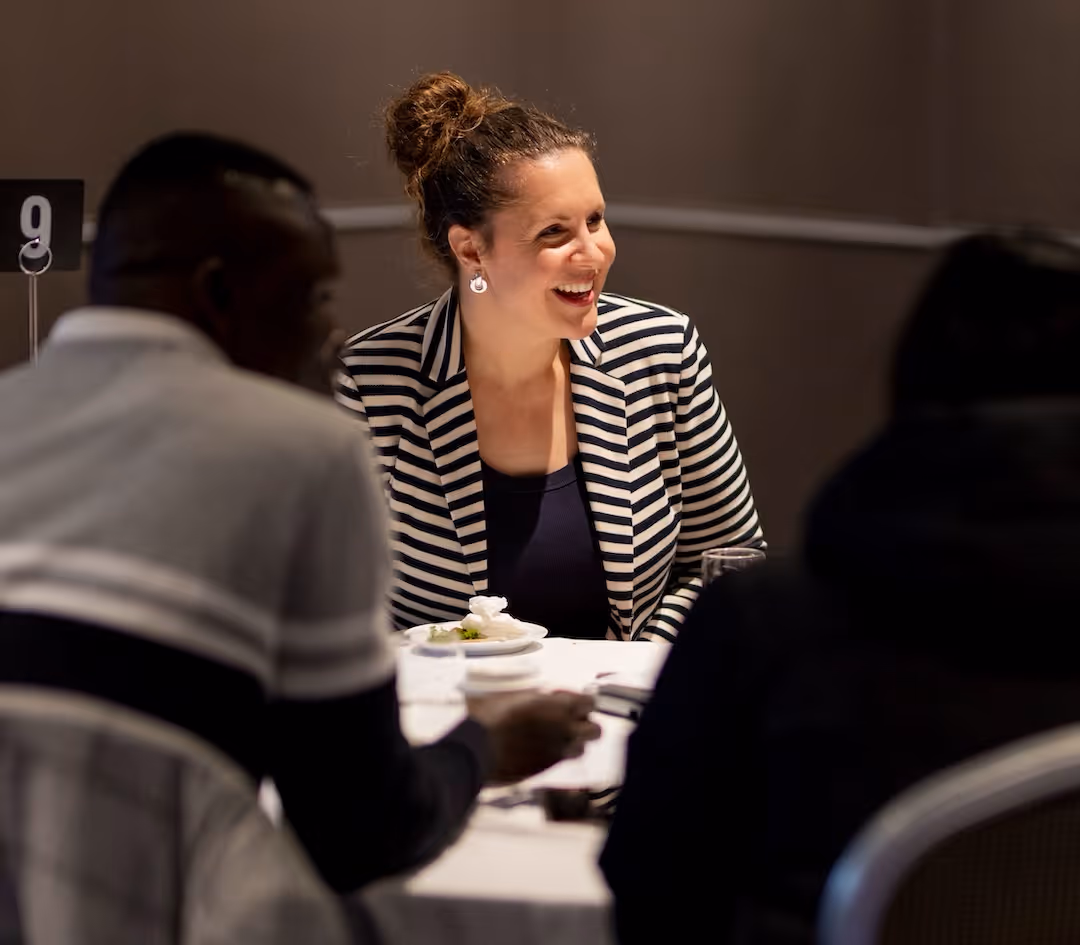 Confident Australian professional holding a laptop after a practical career-development workshop.