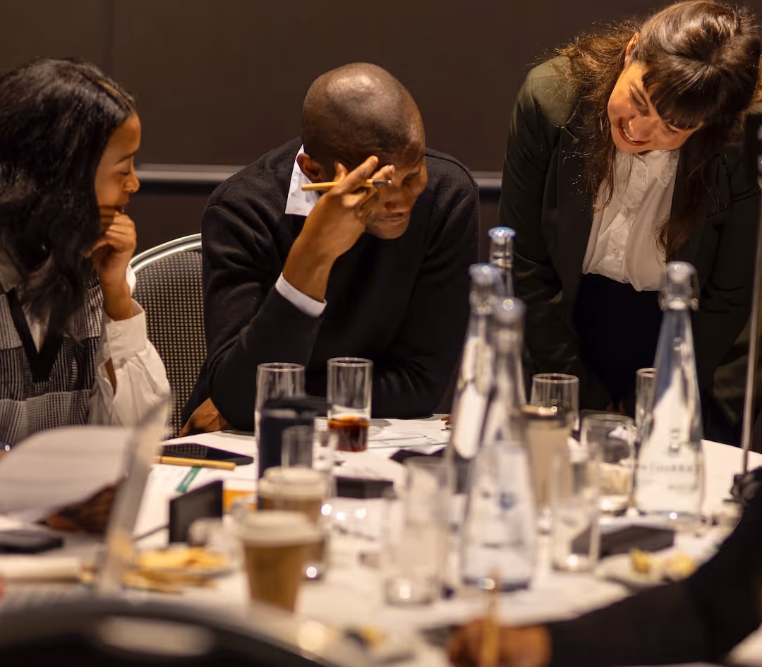 Professional facilitator delivering an adaptable workshop session in a modern civic training space.